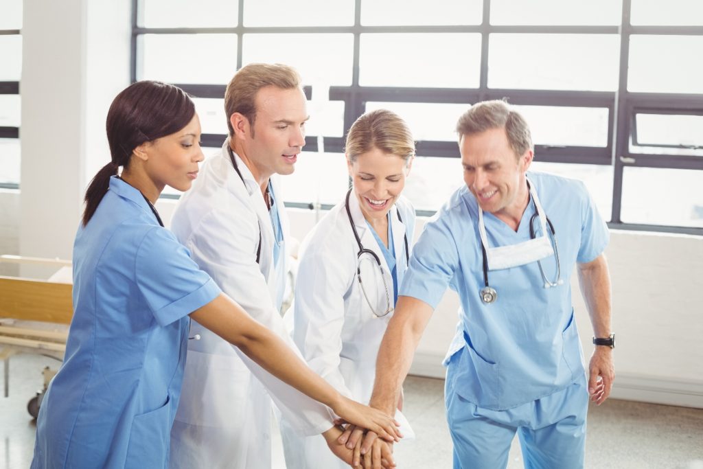 Medical team hands stacked over each other in hospital