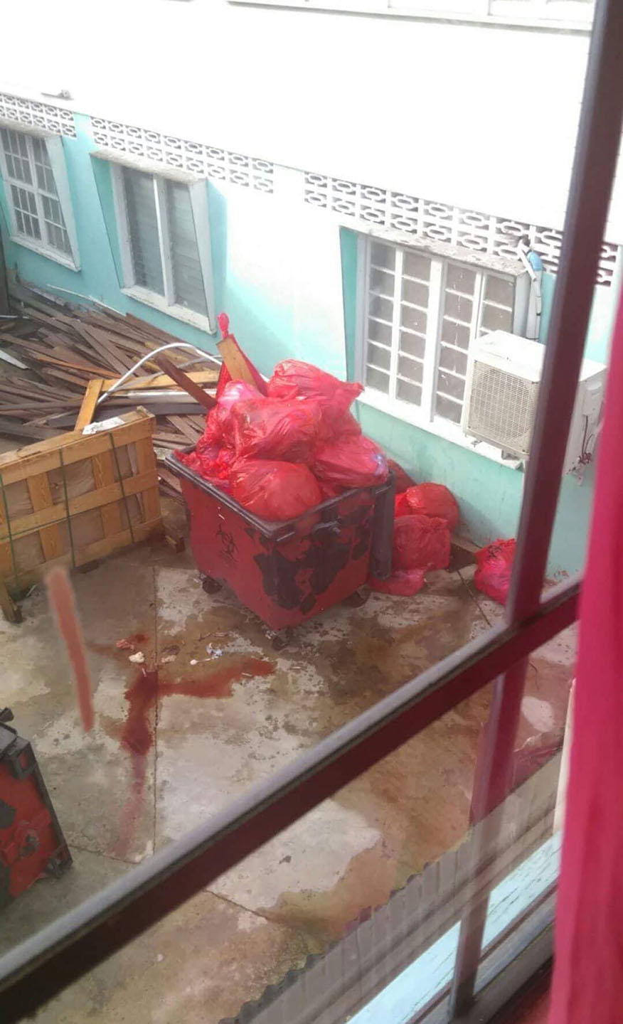 Overfilled Medical Waste Cart And Leaking Biohazard Fluids